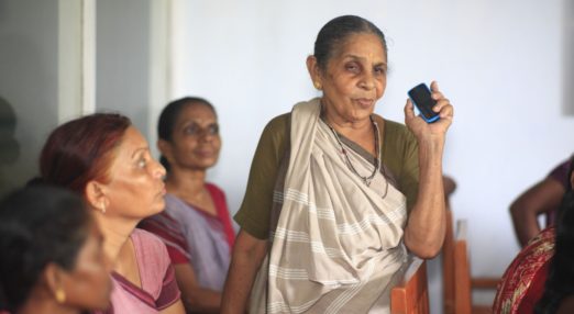 Indian woman holds up a mobile phone