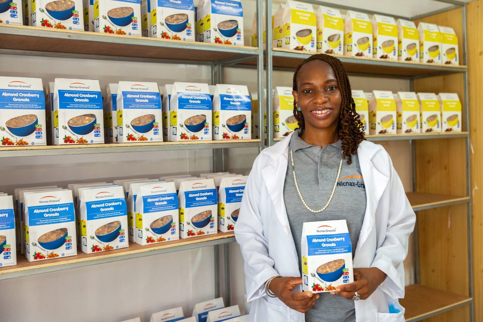 Ejiro Jakpa, the CEO of Nicnax Enterprises, poses for a portrait in front of the shelf where finished Nicnax products are kept for storage at Nicnax Enterprises in Lagos, Nigeria on 28th January 2021. The Cherie Blair Foundation for Women continues to support women entrepreneurs across many African countries, including Nigeria, through their blended learning programmes, like Road to Growth and HerVenture.