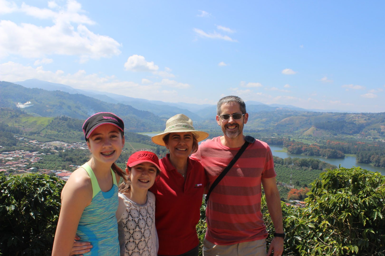 Cecilia, coffee farmer and recycling centre founder, and mentee in the Mentoring Women in Business programme poses with her mentor Paul and his family