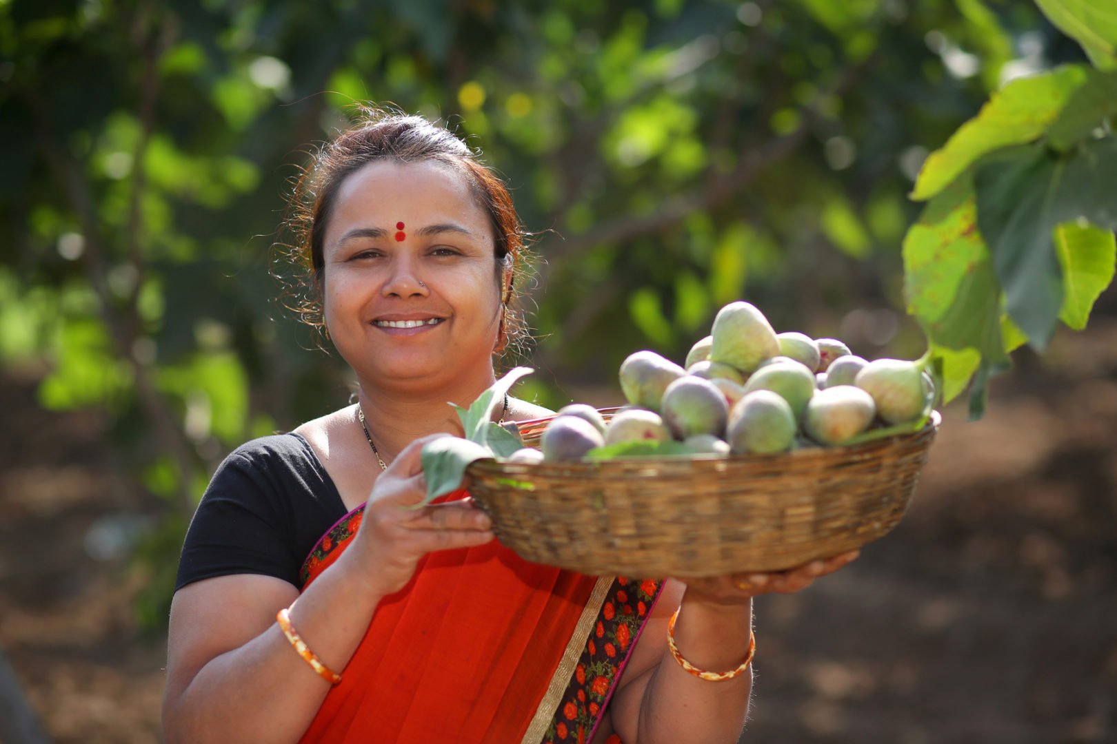 Neeta Mohan poses with fruit at her jam business.