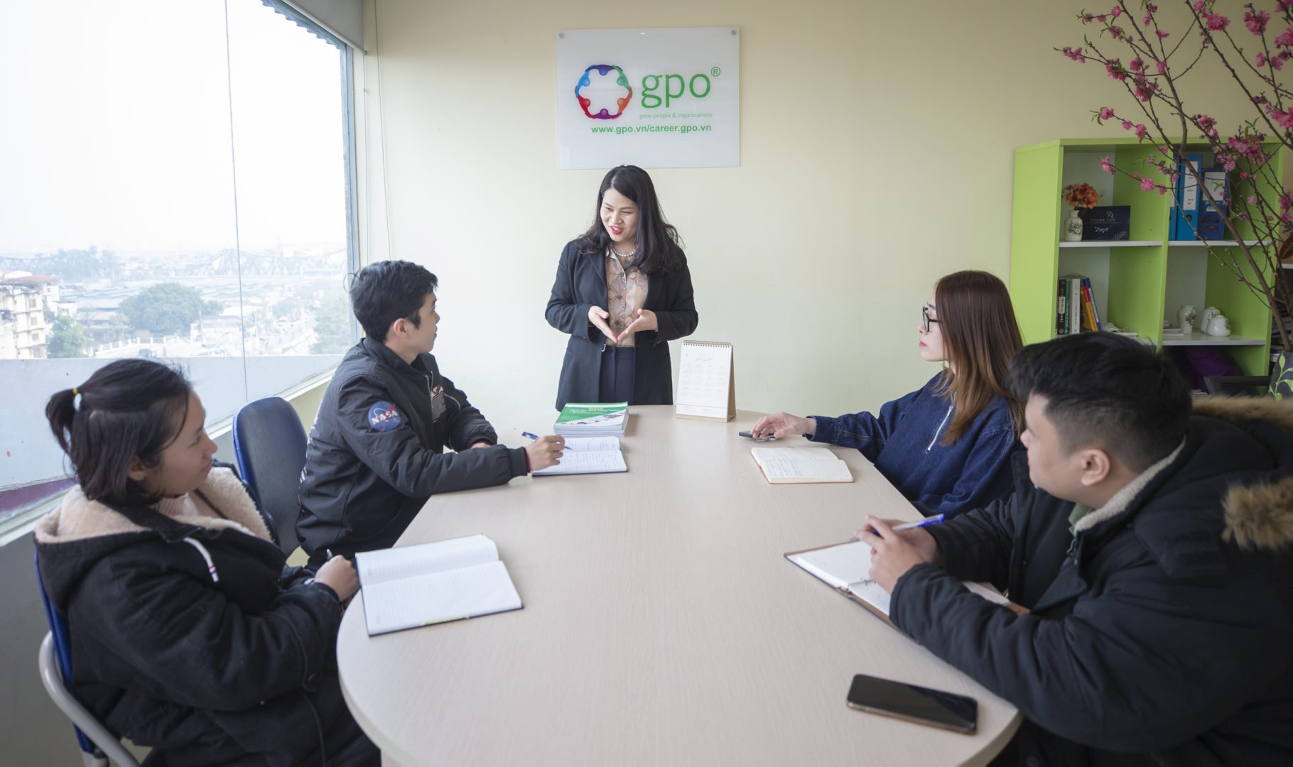 Yen Do, WEAVE participant in Vietnam, leads a meeting with her staff