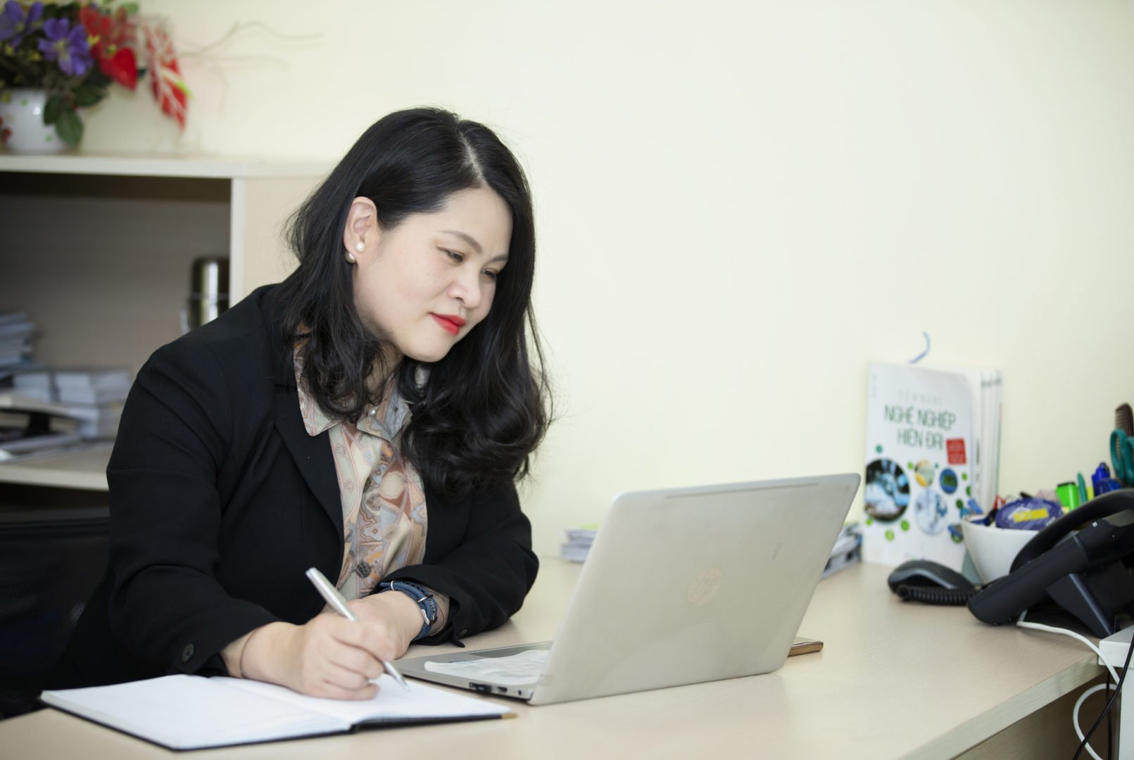 Yen Do, WEAVE participant in Vietnam, does office work