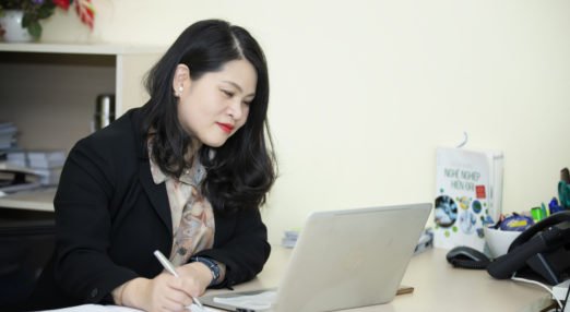 Yen Do, WEAVE participant in Vietnam, does office work