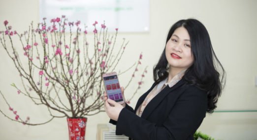Yen Do, WEAVE participant in Vietnam, poses with the HerVenture app