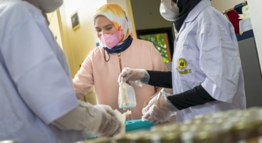 Shinta Aviyani, founder of Imago Raw Honey, and WEAVE alumna works to package honey with her staff