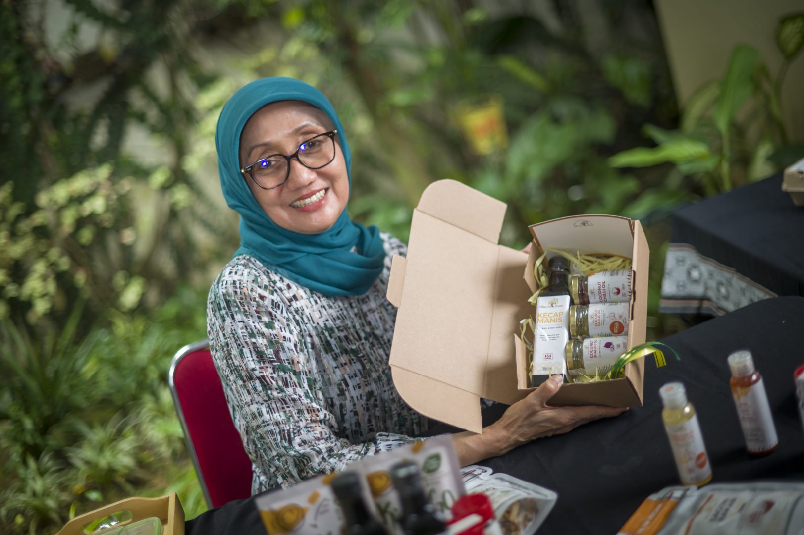 Jullie Hakim holds up a box of her products