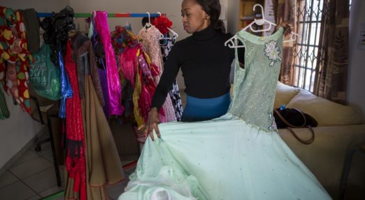 Tebogo poses with a garment at her business