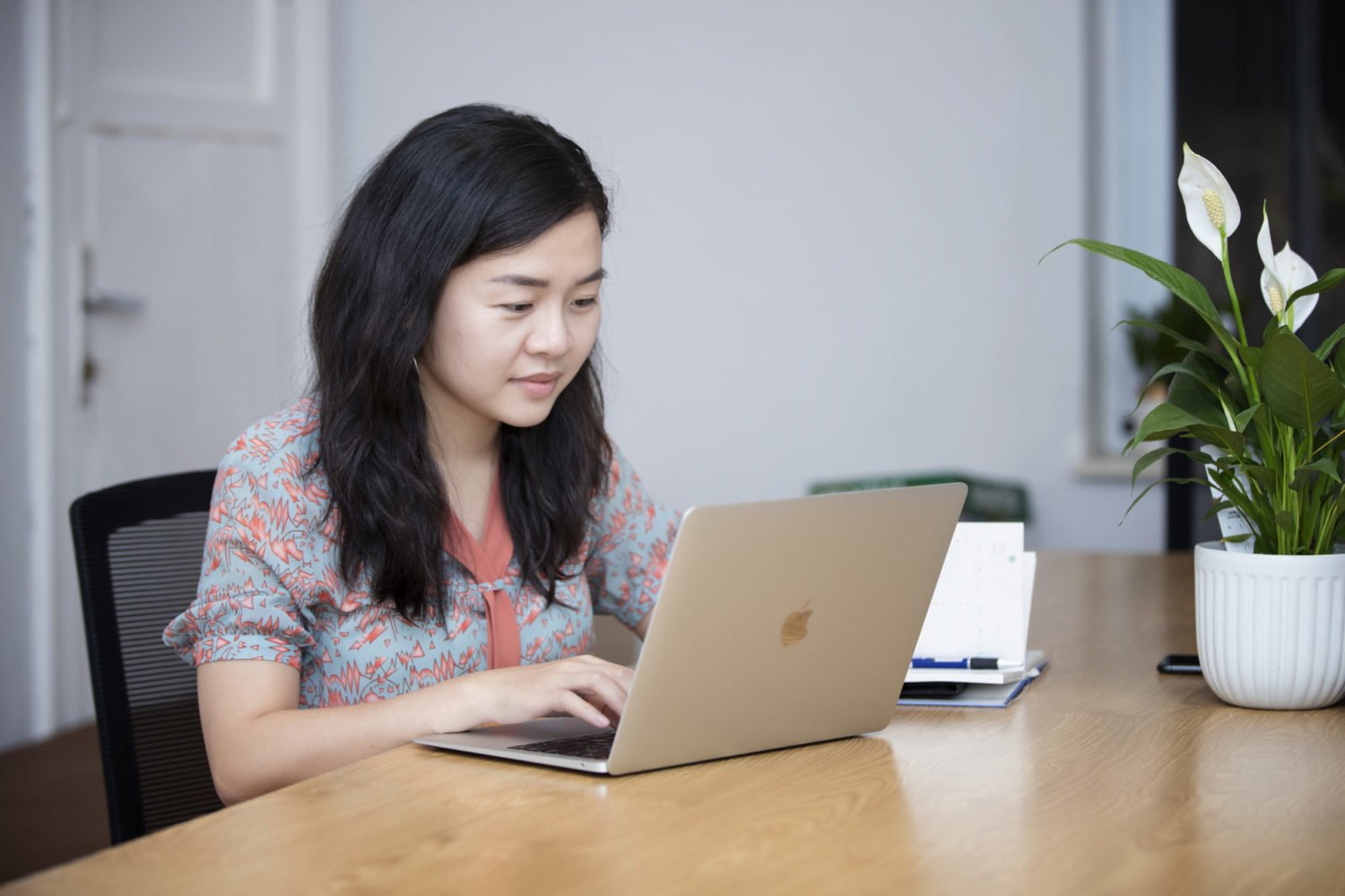 Quynh Nguyen, founder of AZCare, does desk work