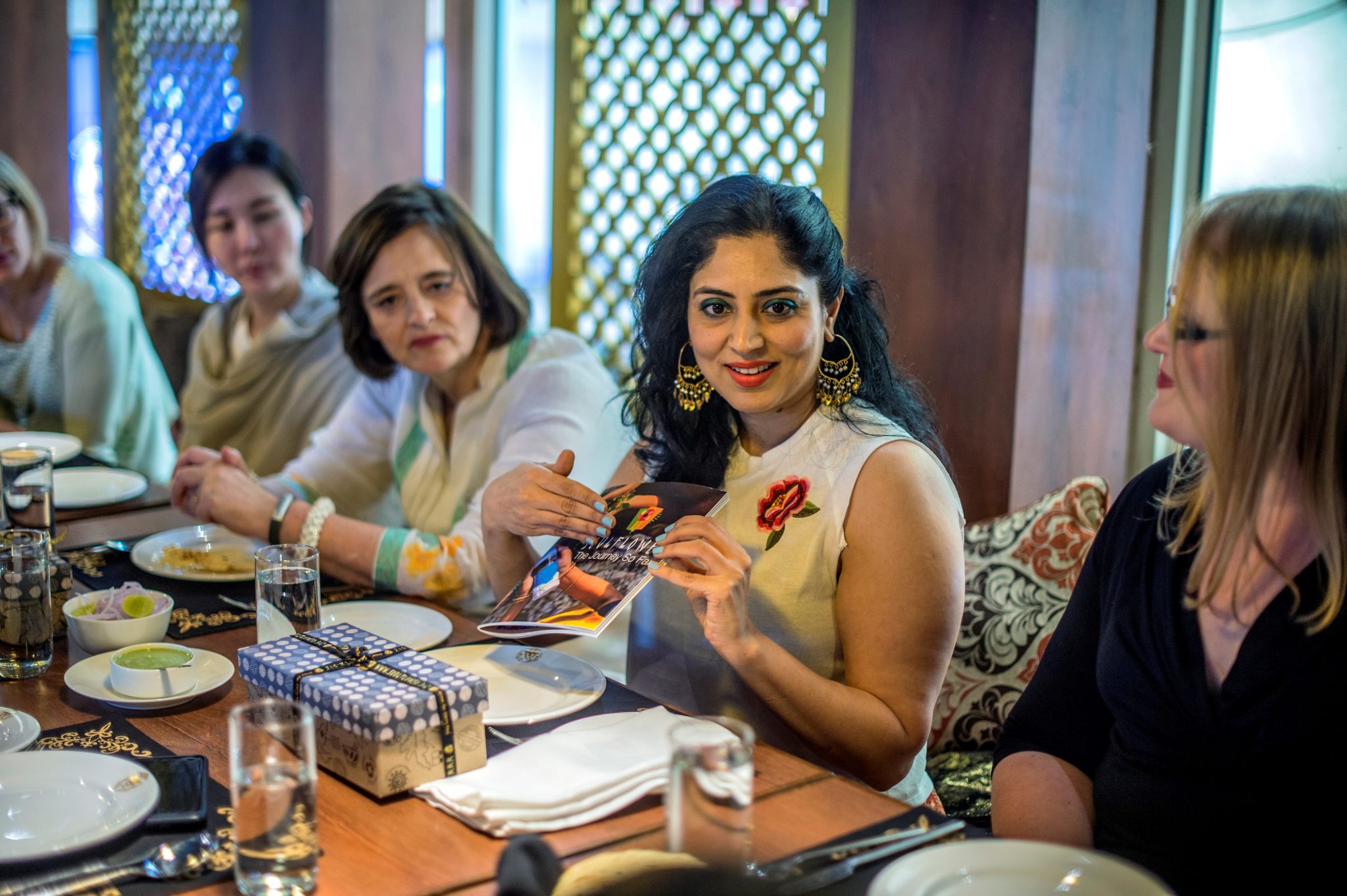 A woman entrepreneur in India speaks to a table of women