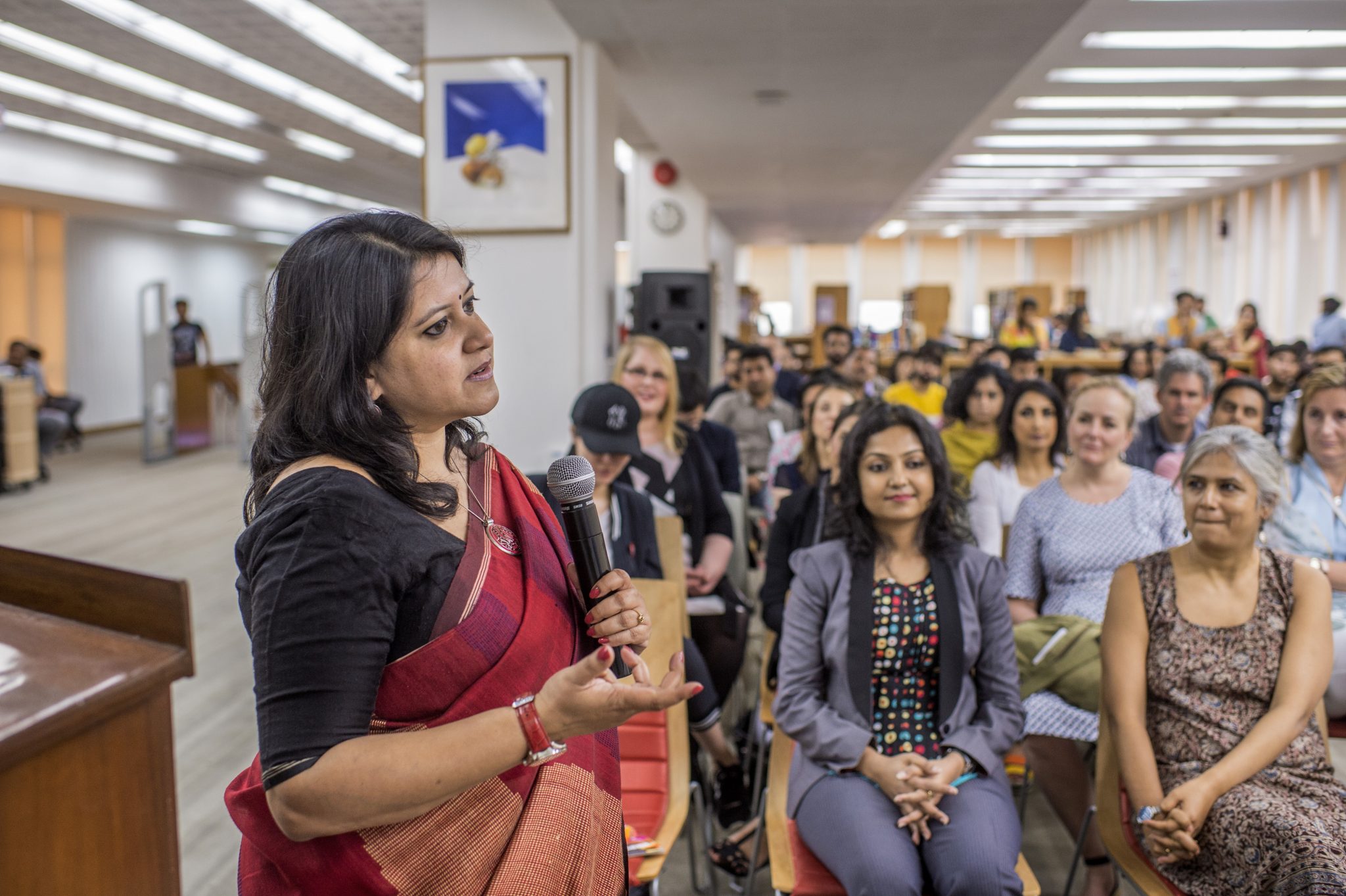 Woman entrepreneur speaks to a room full of women