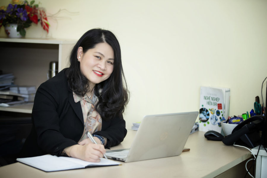 Yen Do works on her computer at her business in Vietnam