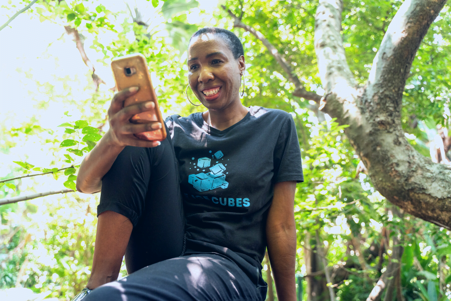 A woman entrepreneur smiles while using the HerVenture app