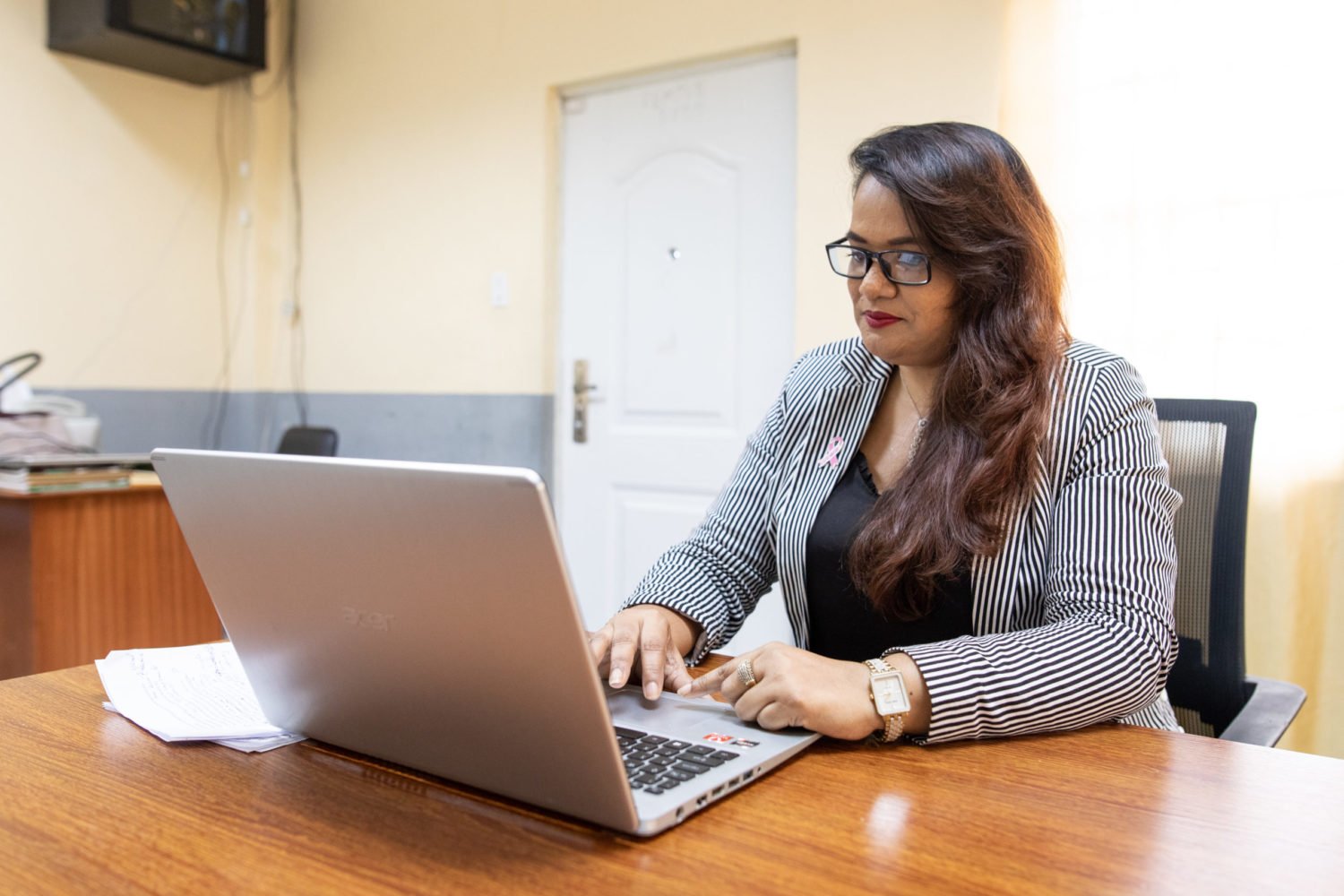 Camille Deokie, a user of the HerVenture app, works on her computer in her office in Georgetown, Guyana on 27 October 2022. The HerVenture app offers women entrepreneurs essential business training and support on the go, with one in 50 women in Guyana now users.