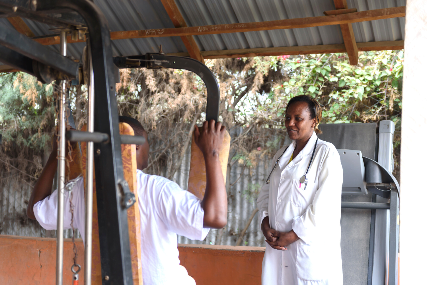 Dr. Catherine Amulundu working with a patient at her health centre