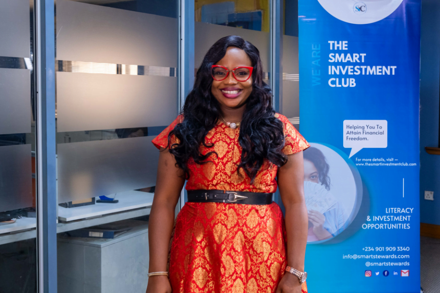 Sola Adesakin poses with The Smart Investment Club sign