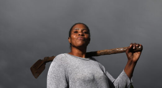 Mercy Manzini, poses with a farming tool in South Africa