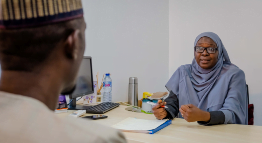 Dr. Hajara Yusuf speaks to a patient at her hospital