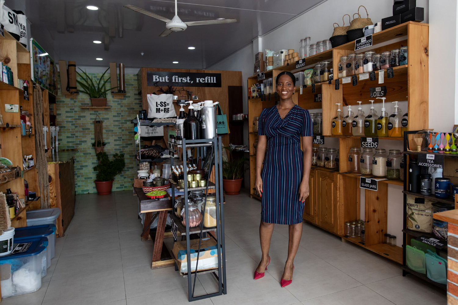 Alana Bunbury-Walton poses with products at her company, JARS zero waste store in Guyana