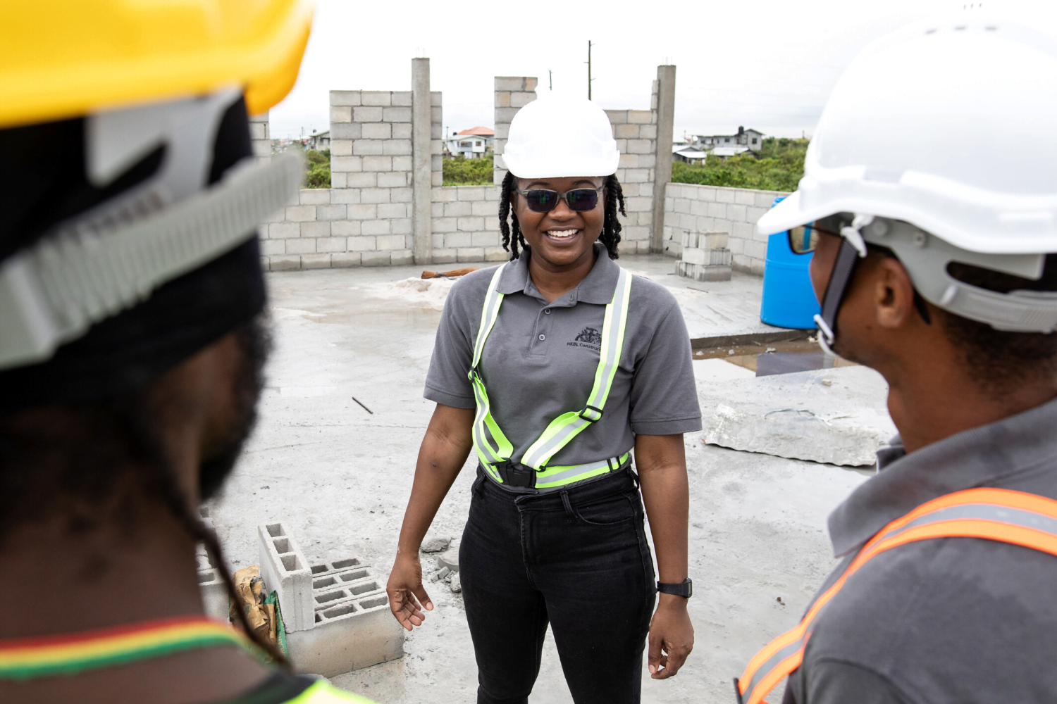 Nakaida Belle- Lindie working with men at her construction business in Guyana