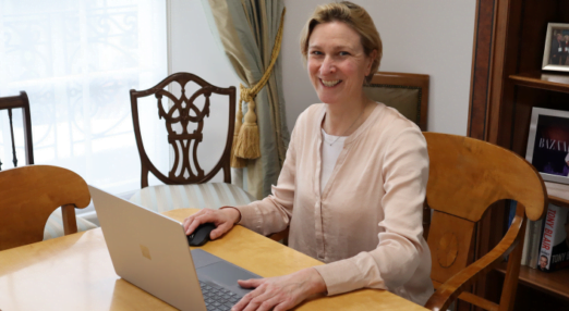 Emily Scott, Director of Programmes smiles at her computer