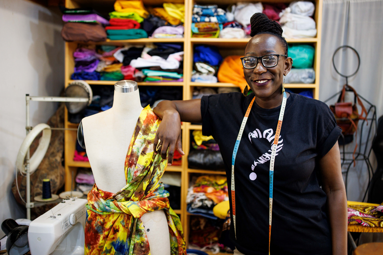 Suubi Njuki poses with a mannequin at her fashion business in Uganda.