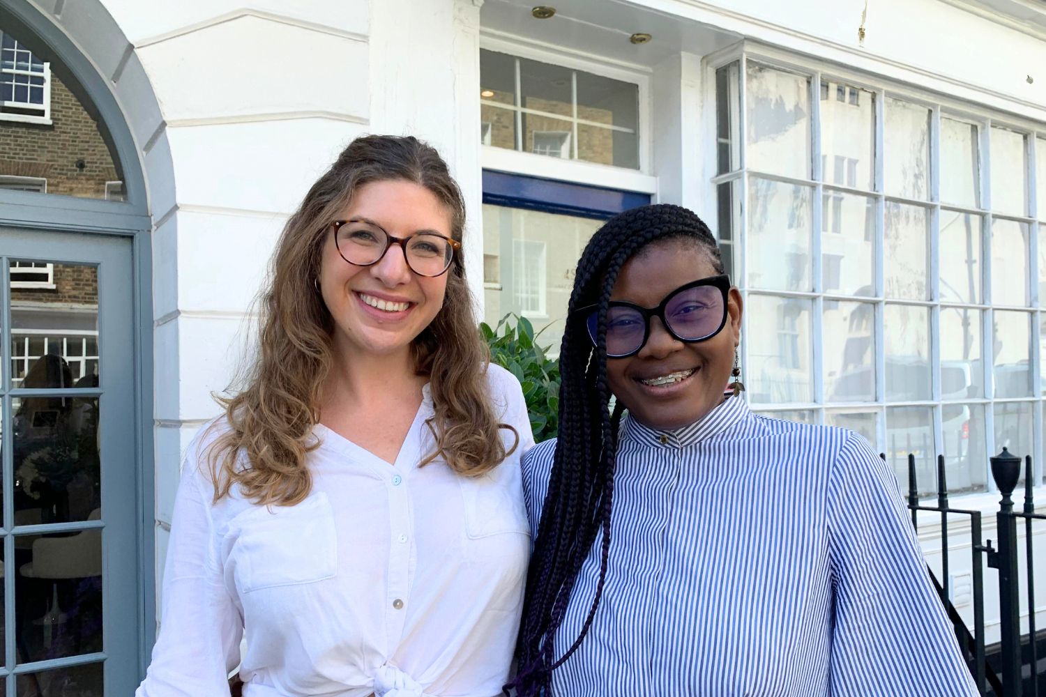 Marcia Skervin, Owner of Connect Your Dots, former mentee poses with Mentoring Programme Manager, Angela Da Silva, outside the Cherie Blair Foundation for Women's offices during a visit to London.