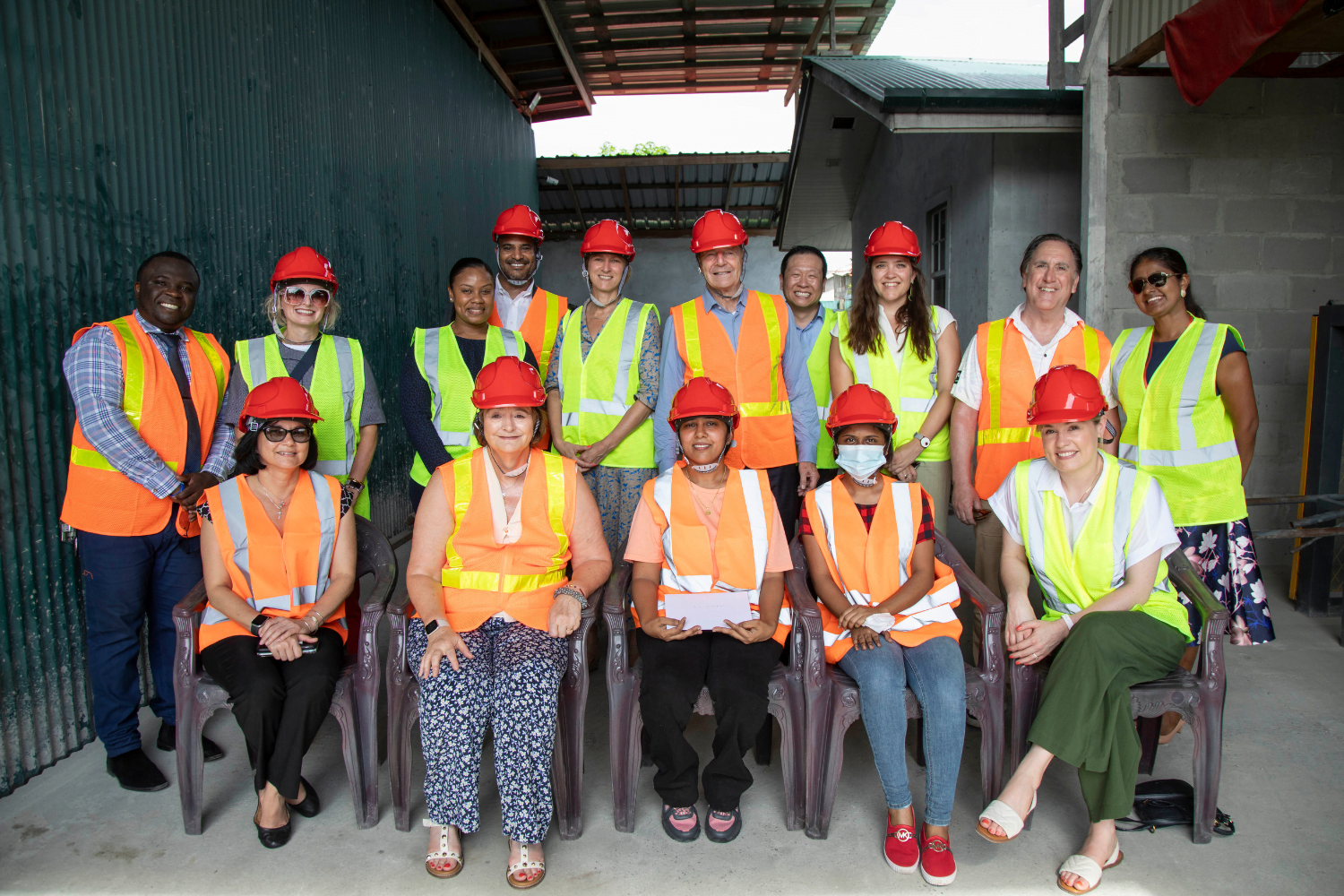 Foundation staff and partners pose at Triple S Zinc and Block factory.
