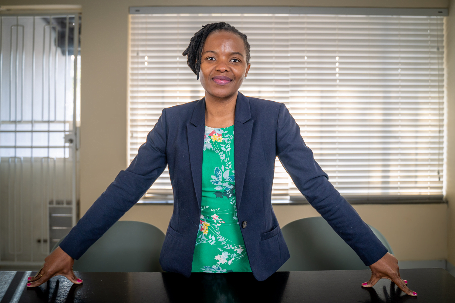 Dudu Makhari, Executive Director of the Ngangezwe Foundation in Johannesburg, South Africa, poses at a desk in her office.