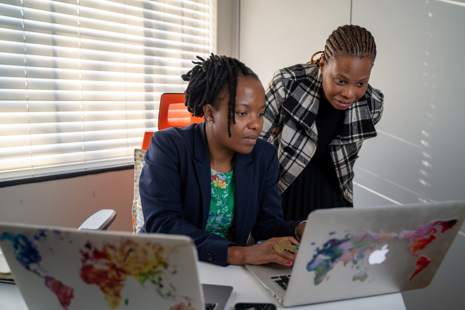 Dudu Makhari, Executive Director of the Ngangezwe Foundation in Johannesburg, South Africa, works with a colleague at her office.