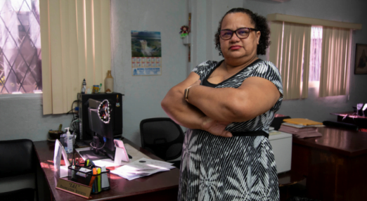 Ivonne Ocrospoma standing proudly at her translation business.