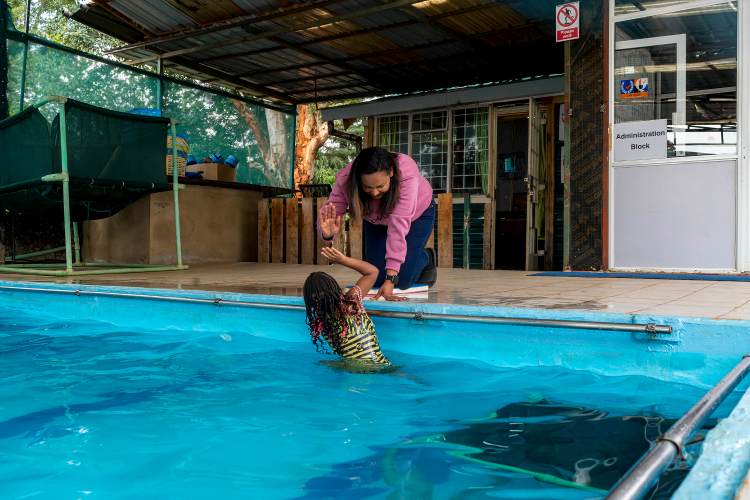 Betty Matharu, Operations Director at Swim Africa, coaches a young swimmer.