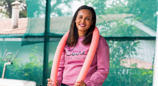 Betty Matharu, Operations Director at Swim Africa, poses with a pool noodle.