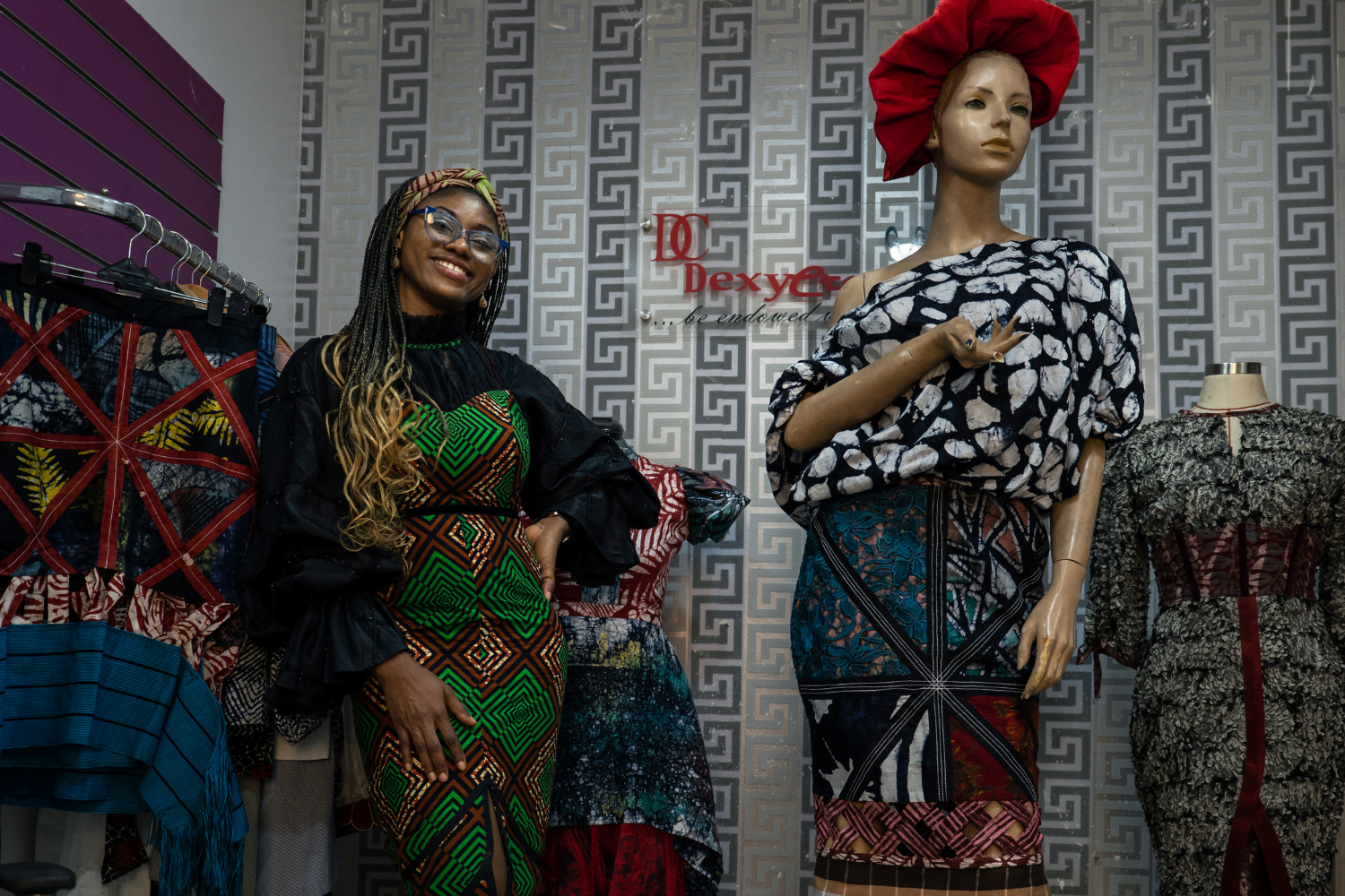 Adaeze Onu poses with dresses at her design company, Dexycreation in Nigeria.