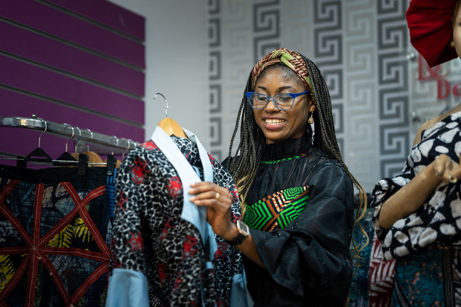 Adaeze Onu hangs garments at her design company, Dexycreation in Nigeria.