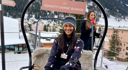 Dhivya O'Connor at Davos with mountains in the background.