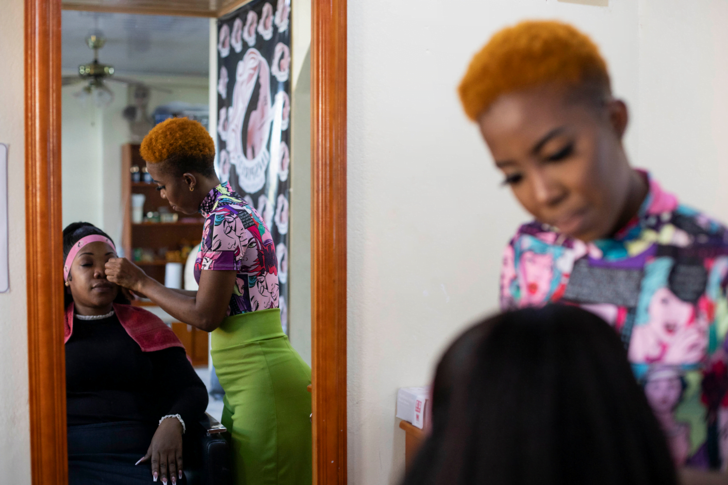 Latoya Rigby, Owner, Inspired Beauty Salon, Guyana works on a client's makeup.