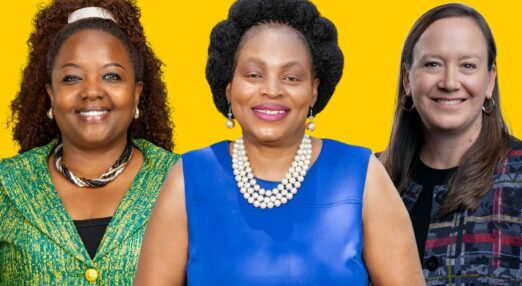 Winnie Wambugu, a black lady with red-brown long, curly hair in a green jacket, Francesca Nxedhlana, a black lady with short, natural black hair in a blue dress with pearls, and Suzanne Ehlers, a white lady with straight brown hair in a dark check jacket. They are standing together smiling against a yellow background.