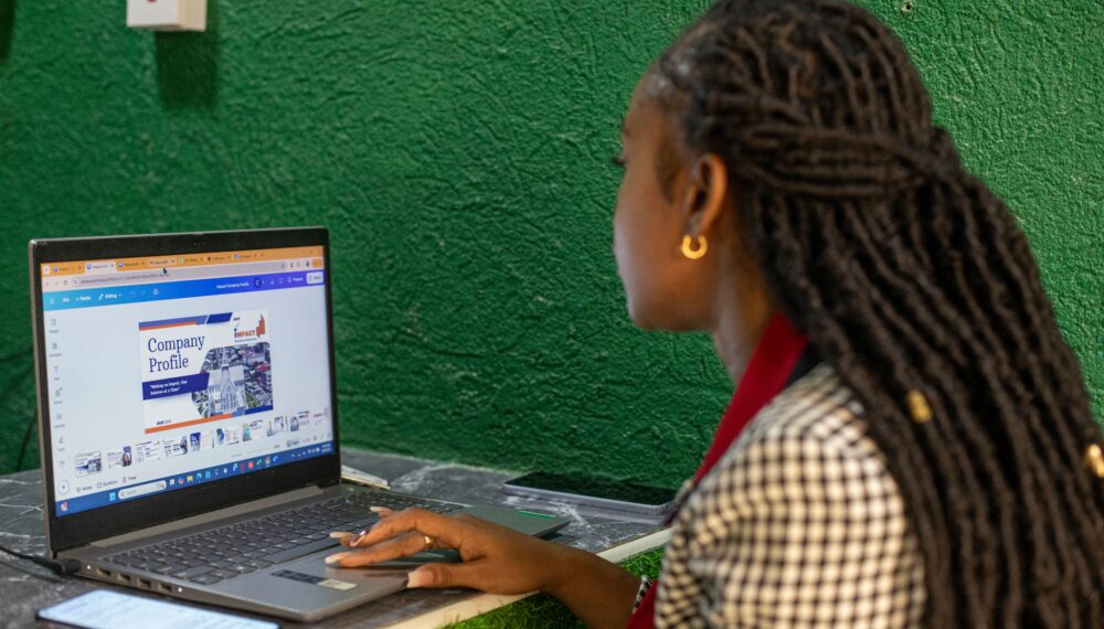Charlyn sits at her desk, using her laptop