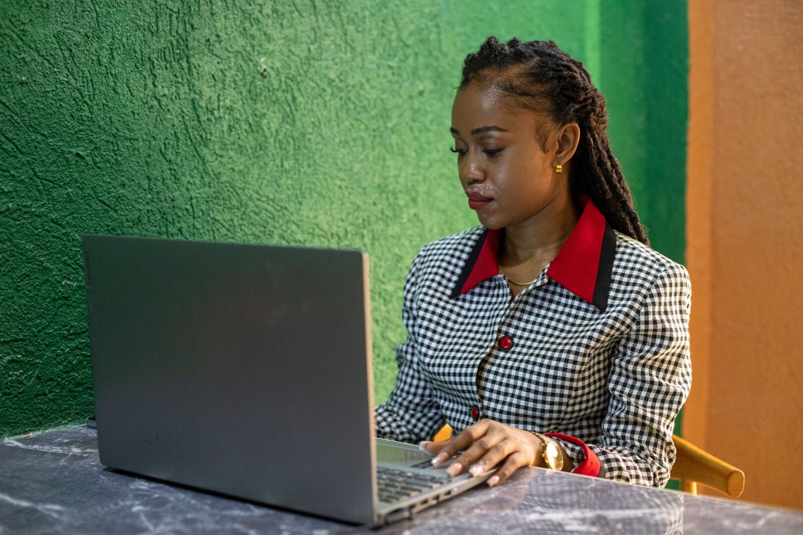 Charlyn Miller sat at a desk using a laptop